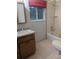 Bathroom featuring a vanity, mirror, bathtub and a window at 11532 Beaman Cir, Clermont, FL 34711