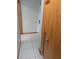 Hallway featuring ceramic tile flooring and a wooden door at 11532 Beaman Cir, Clermont, FL 34711