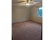 Spacious bedroom with carpet flooring, ceiling fan and a window at 11532 Beaman Cir, Clermont, FL 34711