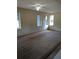Bedroom featuring neutral carpet, ceiling fan, and natural light from multiple windows at 11532 Beaman Cir, Clermont, FL 34711