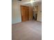 Carpeted bedroom featuring wooden closet doors and trim at 11532 Beaman Cir, Clermont, FL 34711