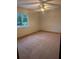 Comfortable bedroom with natural light, ceiling fan, and cozy carpet, perfect for relaxation at 11532 Beaman Cir, Clermont, FL 34711