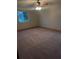 Bright and airy bedroom featuring neutral carpet and natural light from a large window at 11532 Beaman Cir, Clermont, FL 34711