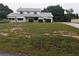 Two-story home featuring a spacious yard, covered parking, and mature trees at 11532 Beaman Cir, Clermont, FL 34711