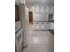 Kitchen view with tile floors and white and blue cabinets and appliances at 11532 Beaman Cir, Clermont, FL 34711