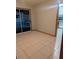 Bright living room with tile flooring and sliding glass doors to the outside at 11532 Beaman Cir, Clermont, FL 34711