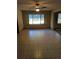 Bright living room with large window, ceiling fan, and tile flooring at 11532 Beaman Cir, Clermont, FL 34711