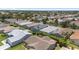 A beautiful aerial view of a residential neighborhood featuring well-maintained homes, lush landscaping, and mature trees at 1334 Hollyberry Pl, The Villages, FL 32162