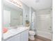 Bathroom featuring a decorative shower curtain, a single sink with a white cabinet, and a framed mirror and wall decor at 1334 Hollyberry Pl, The Villages, FL 32162