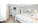 Tranquil bedroom with queen bed, ensuite bathroom, and view to hallway, offering comfortable living space with easy access at 1334 Hollyberry Pl, The Villages, FL 32162