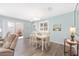 Bright dining room with modern light fixture and sliding door to outdoor patio at 1334 Hollyberry Pl, The Villages, FL 32162
