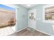 Inviting entryway with stylish flooring, bright door and tranquil decor accents at 1334 Hollyberry Pl, The Villages, FL 32162