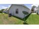 View of the home's exterior featuring siding, window, air conditioning unit, satellite, and well-maintained lawn at 1334 Hollyberry Pl, The Villages, FL 32162