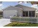 Charming home featuring a two-car garage, landscaped yard, and welcoming curb appeal at 1334 Hollyberry Pl, The Villages, FL 32162