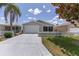 Charming single-Gathering home with white picket fence and attached garage, great curb appeal and landscaping at 1334 Hollyberry Pl, The Villages, FL 32162
