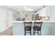 Kitchen counter with bar stool seating showcasing stainless steel appliances at 1334 Hollyberry Pl, The Villages, FL 32162