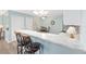 Kitchen counter with bar stool seating overlooking a dining area at 1334 Hollyberry Pl, The Villages, FL 32162