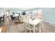 Bright living room featuring a neutral color scheme, wood flooring, and sliding glass doors to the outdoor patio at 1334 Hollyberry Pl, The Villages, FL 32162