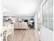 Bright, open-concept living room with hardwood floors and natural light streaming through sliding glass doors at 1334 Hollyberry Pl, The Villages, FL 32162