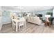 Open concept living and dining area with ample natural light from patio doors at 1334 Hollyberry Pl, The Villages, FL 32162