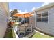 A cozy outdoor patio with a dining area and well-manicured landscaping at 1334 Hollyberry Pl, The Villages, FL 32162