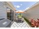 Private patio featuring a grill and an outdoor dining set for relaxation and entertainment at 1334 Hollyberry Pl, The Villages, FL 32162
