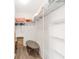 An organized walk-in closet boasts ample shelving and hanging space to accommodate your storage needs, plus a unique table at 1334 Hollyberry Pl, The Villages, FL 32162