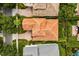 Birds-eye view of a home featuring a distinctive tile roof, brick driveway, and manicured landscaping at 1444 Whitney Isles Dr, Windermere, FL 34786