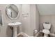 Powder room with pedestal sink, toilet and a decorative mirror at 1444 Whitney Isles Dr, Windermere, FL 34786