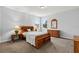 Bright bedroom featuring a wooden bed frame with matching nightstands and dresser at 1444 Whitney Isles Dr, Windermere, FL 34786