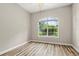 Bright bedroom featuring hardwood floors, a ceiling fan, and a large window at 1444 Whitney Isles Dr, Windermere, FL 34786