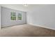 Spacious bedroom showcasing large windows, plush carpeting and neutral paint for a cozy feel at 1444 Whitney Isles Dr, Windermere, FL 34786