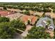 Beautiful home surrounded by lush trees, showcasing its brick driveway and well-maintained landscape at 1444 Whitney Isles Dr, Windermere, FL 34786