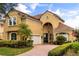 Elegant two-story home with a terra cotta roof and manicured landscaping at 1444 Whitney Isles Dr, Windermere, FL 34786