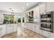 Modern kitchen with white cabinets, stainless steel appliances, and granite counters at 1444 Whitney Isles Dr, Windermere, FL 34786