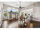 Open living room with hardwood floors, custom built-ins, and bar seating at 1444 Whitney Isles Dr, Windermere, FL 34786