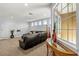 Living area featuring a leather sectional sofa with decorative vases and ample natural light at 1444 Whitney Isles Dr, Windermere, FL 34786