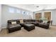 Open living room featuring a large leather sectional sofa and ample natural light at 1444 Whitney Isles Dr, Windermere, FL 34786
