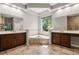 Bright bathroom featuring a soaking tub between and sinks, tiled floors, and tray ceiling with recessed lighting at 1444 Whitney Isles Dr, Windermere, FL 34786