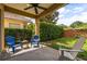 Covered patio with blue chairs, a ceiling fan, string lights, and a view of the landscaped yard at 1444 Whitney Isles Dr, Windermere, FL 34786