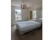 Cozy bedroom with chandelier, featuring natural light from the window at 149 Roseling Xing, Davenport, FL 33897