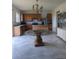 Well-lit kitchen with wood cabinetry, stainless steel appliances, and a glass dining table at 149 Roseling Xing, Davenport, FL 33897