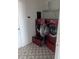 Laundry room featuring two LG washing machines with an open container and patterned floors at 149 Roseling Xing, Davenport, FL 33897