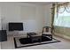 Neutral living room featuring oriental rug, oriental chair, and large window at 149 Roseling Xing, Davenport, FL 33897