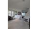 Living room with white sofa set, bench and artwork on the white walls at 149 Roseling Xing, Davenport, FL 33897