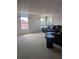 Bright living room features a comfortable couch and natural light from several windows at 149 Roseling Xing, Davenport, FL 33897