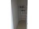 Walk in storage room with white wire shelving and tiled floors at 149 Roseling Xing, Davenport, FL 33897