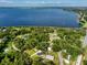 Aerial view of property location in proximity to Lake Minneola, surrounding mature trees, and neighboring homes at 16615 Oklahoma St, Clermont, FL 34715