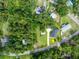 Aerial view of property including adjacent land, driveway, and surrounding mature trees at 16615 Oklahoma St, Clermont, FL 34715