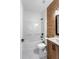 Bathroom features shower-tub, wood accent wall, and modern fixtures at 16615 Oklahoma St, Clermont, FL 34715